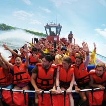 a group of people in a raft in the water