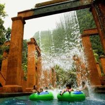 a group of children riding on tubes in a fountain