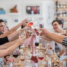 a group of people holding up glasses of wine