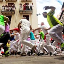 a group of people running down a street