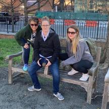 drie vrouwen zitten op een parkbank