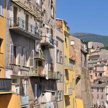 a group of buildings with balconies and apartments