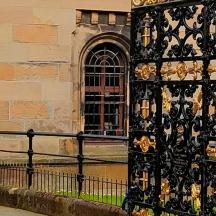a black and gold door on the side of a building
