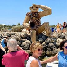 a group of people standing in front of a statue
