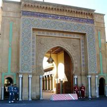 an arch with people standing in front of a building
