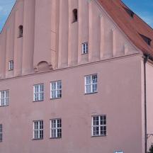 a large pink building with a red roof
