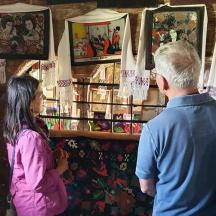 a man and a young girl looking at art in a store