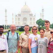 a group of people standing in front of the taj mahal