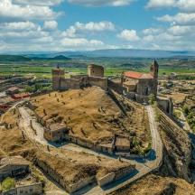 an aerial view of an old building on a hill