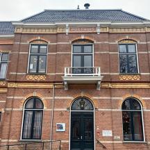 a red brick building with a balcony on the front