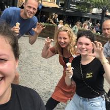 a group of people posing for a picture with ice cream