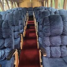 an empty bus with blue seats on a bus