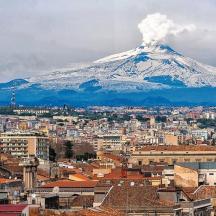 a view of a city with a snow covered mountain