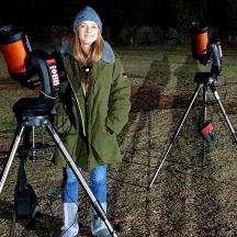 a woman standing in front of two cameras