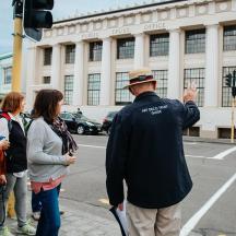a group of people waiting to cross the street