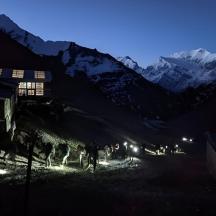a group of people walking down a mountain at night
