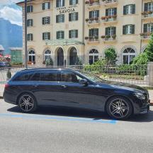 a black car parked in front of a building