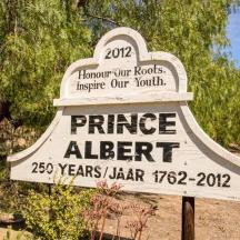 a sign for a price alert in a park