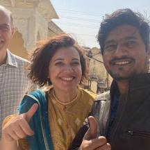 two men and a woman posing for a picture