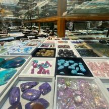 a display case filled with lots of different colored stones