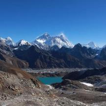 a mountain range with a lake in the foreground