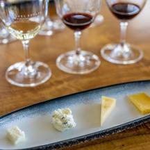 un piatto di formaggio e bicchieri di vino su un tavolo