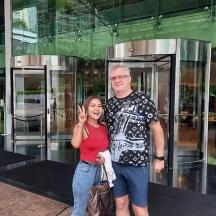 a man and a woman standing in front of a building