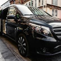 a black car parked on the side of a street