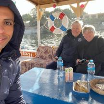 a group of people sitting at a table on a boat