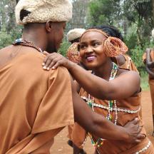 a woman is hugging a man in a tribe