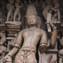 a stone statue of a man holding a sign
