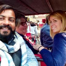 a man and two women sitting on a bus
