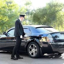 a man standing next to a black car