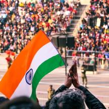 a group of people holding a flag in front of a crowd