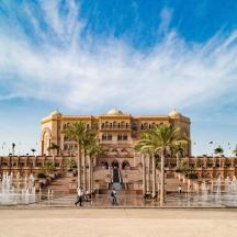 a large building with a fountain in front of it