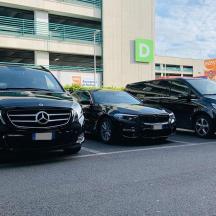 drie auto's geparkeerd op een parkeerplaats voor een gebouw