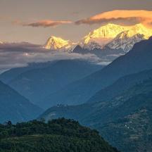 a view of a mountain range with clouds in the sky