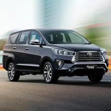 a black toyota fortuner driving down the street