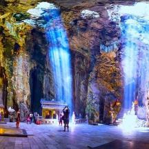 a large room with blue lights in a cave