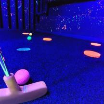 a game of snooker in a purple room with a stick