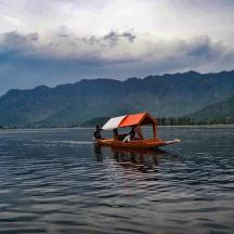 a small boat with a canopy on the water
