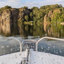 a boat on a river with trees in the water