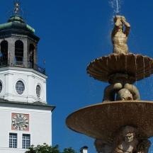 a building with a clock tower and a fountain
