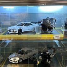 a display case with cars and robots on display