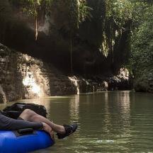a man is sitting on a raft in a river