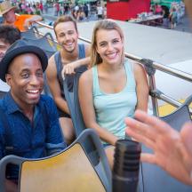 a group of people sitting on a roller coaster