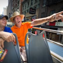 a man in a hat is pointing at a person