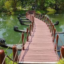a wooden bridge over a lake in a park