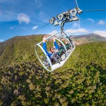 a group of people riding a gondola over a mountain