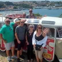 a group of people standing in front of a van